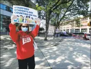  ?? Matthew Brown / Hearst Connecticu­t Media ?? Diane Phanos, president of Stamford teachers union, along with teachers, parents and other community members, attends a rolling rally around the Stamford Government Center on Thursday to urge city officials to not impose more than $15 million in cuts to education.