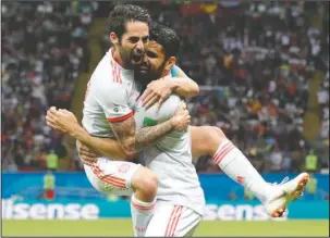  ?? The Associated Press ?? COSTA SCORES THIRD: Spain’s Diego Costa, right, celebrates after scoring his side’s opening goal with Spain’s Isco during the Group B match between Iran and Spain at the 2018 World Cup at Kazan Arena in Kazan, Russia, Wednesday. The goal was Costa’s...
