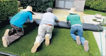  ?? Luis Sinco Los Angeles Times ?? THE GLENDALE City Council also will discuss regulating types of material used in artificial lawns. Some materials may retain more heat or smells from animal waste, but better materials could mean higher costs.