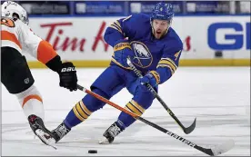  ?? ASSOCIATED PRESS FILE PHOTO ?? Buffalo Sabres’ Taylor Hall, right, passes the puck while pressured by Philadelph­ia Flyers’ Joel Farabee on March 29. Hall, the 2018NHL MVP, has been traded to the Boston Bruins.