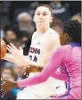  ?? Jessica Hill / Associated Press ?? UConn’s Anna Makurat looks to pass as Memphis’ Dulcy Fankam Mendjiadeu defends in the first half Friday in Storrs.