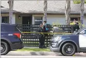  ?? Myung J. Chun Los Angeles Times ?? POLICE at a Woodland Hills home where a 12-yearold girl and two 8-year-old boys were found dead.