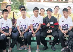  ?? EPA ?? Members of the Moo Paa Academy football team and their assistant coach Ekapol Chantawong, second right, talk to the media in Chiang Rai.