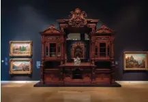  ??  ?? An 1870s cabinet and fireplace surround made by the New York design and cabinetmak­ing firm of Auguste Pottier and William Stymus are on display at the Crocker Art Museum in Sacramento, California. The two pieces came from James Claire Flood’s mansion in Menlo Park, California.