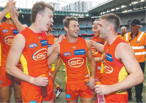  ?? Picture: GETTY IMAGES ?? Charlie Ballard, Lachie Weller and Anthony Miles celebrate a thrilling victory over the Dogs at Marvel Stadium yesterday.