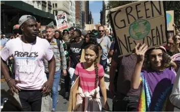  ?? AP PHOTO/EDUARDO MUNOZ ALVAREZ ?? Swedish environmen­tal activist Greta Thunberg (center) takes part during the Climate Strike, on Friday in New York.