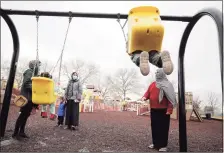  ?? Getty Images ?? Afghan refugee mothers and children play in a park in Liberty Village on Dec. 2 in Joint Base McGuire-Dix-Lakehurst, N.J.