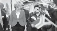  ?? REUTERS ?? British Prime Minister Theresa May is greeted by school children waving flags during her visit in South Africa on Tuesday.