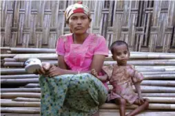  ?? TODD PITMAN/THE ASSOCIATED PRESS ?? Rosmaida Bibi, right, who suffers from severe malnutriti­on, sits with her 20-year-old mother Hamida Begum. Rosmaida looks like an underfed 1-year-old — but she’s 4.