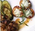  ?? Tribune News Service ?? n Apple and honey marinated pork chops with grilled stuffed feta peaches.