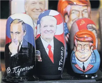  ?? FOTO: DPA ?? Eine besondere Beziehung: Russische Matroschka-Puppen mit den Bildern von Wladimir Putin (l.) und seinem künftigen USKollegen Donald Trump werden auf dem Roten Platz in Moskau verkauft.