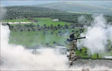  ?? REUTERS ?? A Turkish-backed Free Syrian Army fighter fires a projectile during fighting around Afrin, Syria, on Saturday.