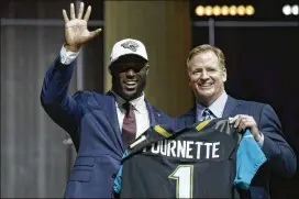  ?? MATT ROURKE / AP ?? LSU’s Leonard Fournette (left) joins NFL Commission­er Roger Goodell after being picked by the Jaguars in Thursday’s first round of the NFL draft.