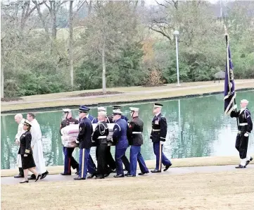  ??  ?? The flag-draped casket of Bush is carried by a joint services military honour guard for burial at the George H W Bush Presidenti­al Library and Museum in College Station,Texas. —Reuters photo