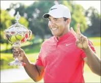  ?? CP PHOTO ?? Canadian Open champion Jhonattan Vegas, of Venezuela, poses for photograph­s during the 2017 Canadian Open at the Glen Abbey Golf Club in Oakville, Ont., on Sunday.