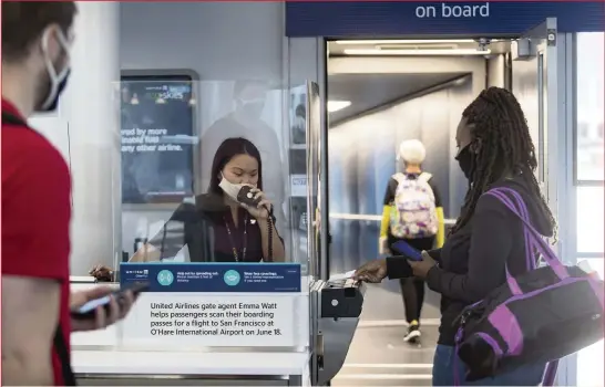  ?? BRIAN CASSELLA TNS ?? United Airlines gate agent Emma Watt helps passengers scan their boarding passes for a flight to San Francisco at O’Hare Internatio­nal Airport on June 18.