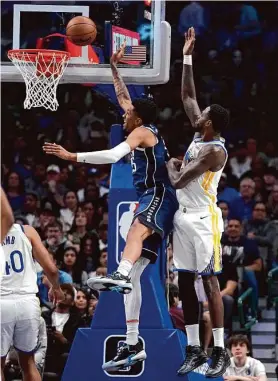  ?? Tony Gutierrez/Associated Press ?? The Mavericks’ Christian Wood gets inside of Draymond Green as the Warriors have a defensive breakdown in Wednesday’s 127-125 road victory.