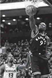  ?? Cole Burston / Getty Images ?? Dewayne Dedmon, left, and the Kings could hardly slow the Raptors’ Serge Ibaka, who scored 21 points.