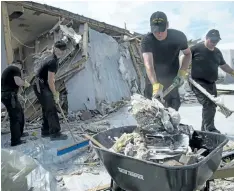  ?? THE CANADIAN PRESS ?? The crew of the HMCS St. John’s continues clean up operations at a school on South Caicos Island during Operation RENAISSANC­E, the hurricane Irma humanitari­an aid mission in the Caribbean earlier in September. The crew arrived Sunday in Dominica to...