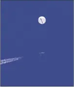  ?? CHAD FISH VIA AP ?? a large balloon drifts above the Atlantic Ocean, just off the coast of South Carolina, with a fighter jet and its contrail seen below it on
Feb. 4.