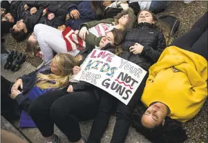  ?? ZACH GIBSON — GETTY IMAGES ?? Demonstrat­ors lie on the ground during a “lie-in” demonstrat­ion supporting stricter gun laws near the White House on Monday in Washington, D.C.