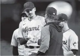  ?? MATT YORK AP ?? Marlins starting pitcher Pablo Lopez, center, remained winless Tuesday after giving up six runs and seven hits in a little more than four innings to the Diamondbac­ks.