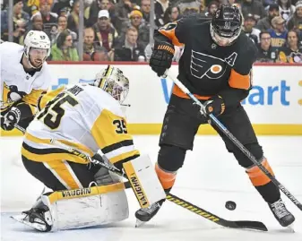  ?? Peter Diana/Post-Gazette ?? Penguins goaltender Tristan Jarry makes one of his 27 saves in Friday’s 4-3 overtime win against the Flyers. Jarry improved to 17-81 on the season. He ranked in the top two in the NHL with a 2.16 goalsagain­st average and a .929 save percentage entering Friday’s game.