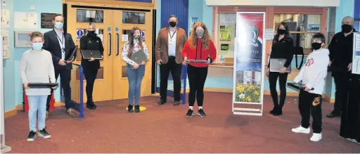  ?? Picture: QE High School ?? Nigel Cooke, QE High School business manager, Clare Stansfield, marketing manager, headteache­r Dave Williams, Mererid James, sustainabi­lity executive at Puffin Produce and Jonathan James, Puffin Produce’s IT executive, with key worker children at the school.