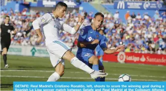  ?? — AP ?? GETAFE: Real Madrid’s Cristiano Ronaldo, left, shoots to score the winning goal during a Spanish La Liga soccer match between Getafe and Real Madrid at the Coliseum Alfonso Perez in Getafe, Spain.