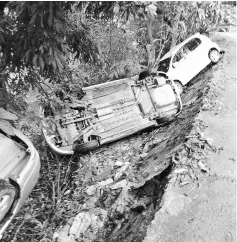  ??  ?? Four vehicles fell into a ditch after a section of the concrete road collapsed at Prosperous Village.