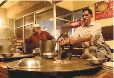  ??  ?? A chef prepares the famous taka tak made from goat organs.