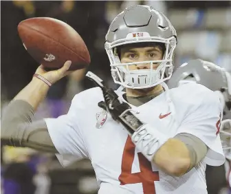  ?? AP PHOTO ?? ONE TO TARGET? Washington State’s Luke Falk is among the quarterbac­ks who could be available in the middle rounds should the Patriots choose that path.