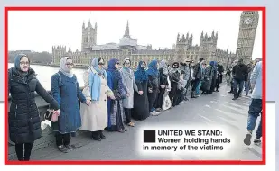  ??  ?? ®Ê UNITED WE STAND: Women holding hands in memory of the victims
