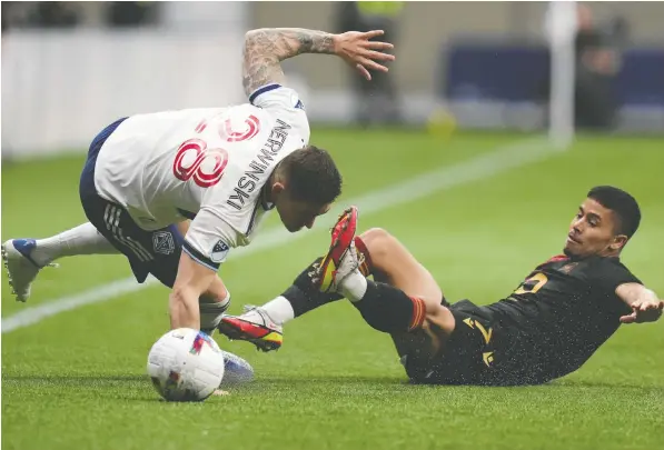  ?? — THE CANADIAN PRESS ?? The Whitecaps' Jake Nerwinski, left, and Valour FC's Moses Dyer collide while vying for the ball during the first half of their Canadian Championsh­ip preliminar­y round match at B.C. Place Stadium on Wednesday.