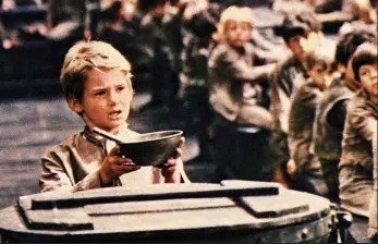  ??  ?? Please sir, I want some more: The orphan’s appeal for food in the film Oliver!