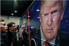  ?? Photograph: Shawn Thew/EPA ?? Conference attendees gaze at a poster of former president Donald Trump at the Conservati­ve Political Action Conference on 22 February 2024.