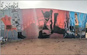  ?? ?? Back to the wall: A mural in Sudan’s capital Khartoum depicting the war by artists Yasir Aglrai and Hani Khalil.