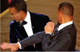  ?? ?? Moment of anger: Smith slaps Oscars host Chris Rock on stage