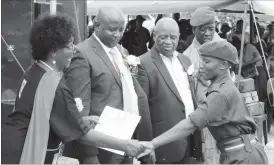  ??  ?? Minister of Women and Youth Affairs Cde Sithembiso Nyoni presents a certificat­e to the best student Surprize Gumede at a National Youth Service graduation in Pumula on Thursday. Looking on (from left) are Zanu-PF Secretary for Youth Affairs Cde Pupurai...