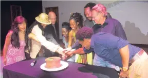  ??  ?? Organisers of Cinema Paradise and stakeholde­rs of ‘Rasta: A Soul’s Journey’ getting ready to cut the Marcus Garvey birthday cake.