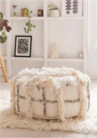 ?? URBAN OUTFITTERS ?? A Moroccan-inspired pouf, which sports a shaggy trim, sequins and a geometric motif.