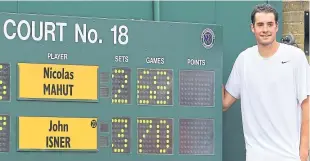  ?? Picture: PA. ?? John Isner stands by the final scoreboard after his marathon win over Nicolas Mahut at Wimbledon in 2010.