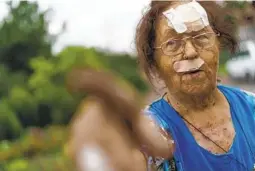  ?? DAVID GOLDMAN AP ?? Valentyna Kondratiev­a, 75, points to her damaged home, Saturday after she was injured by Russian rockets in Kramatorsk, Ukraine.