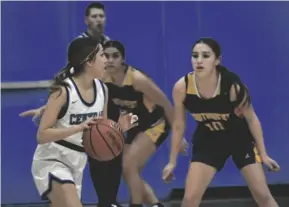  ?? ODETT OCHOA PHOTO ?? Central Spartan Addison Zavala (left, in foreground) dribbles the ball against the Southwest Eagles during a nonleague girls basketball game on Friday, January 6, at Spartan Arena in El Centro.