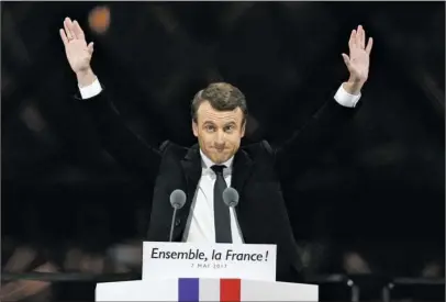  ?? The Associated Press ?? ‘IMMENSE TASK’: French President-elect Emmanuel Macron gestures during a victory celebratio­n Sunday outside the Louvre museum in Paris. Speaking to thousands of supporters from the Louvre Museum's courtyard, Macron said that France is facing an...