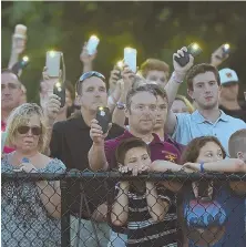  ?? STAFF PHOTOS BY CHRISTOPHE­R EVANS ?? SHOW OF SUPPORT: Brother Eric Chesna, top left, comforts his mother, Maryann Chesna, as father Chuckie, right, stands close during a vigil, left and above, for slain Weymouth police Sgt. Michael Chesna and bystander Vera Adams last night at Weymouth...