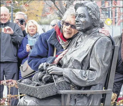  ?? Cp photo ?? Charlotte Guy Jeffries embraces the sculpture, The Seated Woman, one of three, as the Halifax Women’s History Society officially unveils a bronze monument, The Volunteers/les Benevoles, to pay tribute to women volunteers during the Second World War, in...