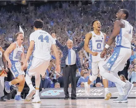  ?? DAVID J. PHILLIP/ASSOCIATED PRESS ?? North Carolina head coach Roy Williams and players celebrate after the Tar Heels beat Gonzaga in the finals of the NCAA Tournament.
