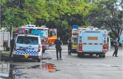  ?? AFTERMATH: Police and firefighte­rs secure the scene after yesterday’s explosion at Townsville Golf Club. ??