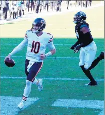  ?? SAM GREENWOOD/GETTY ?? Mitchell Trubisky runs for a touchdown during the third quarter against the Jacksonvil­le Jaguars.